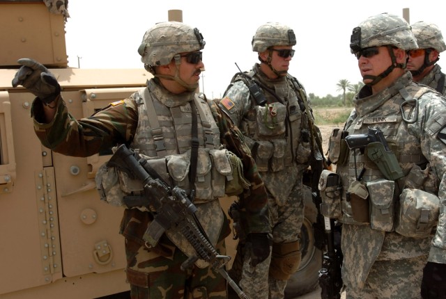 CAMP TAJI, Iraq - Roundup, Mont. native Col. Paul E. Funk II (right), commander, 1st Bridgade Combat Team, 1st Cavalry Division visits a traffic control point (TCP) near Naif Al Hasan, Iraq in June 2007 with Lt. Col. Scott Efflandt (center), commande...