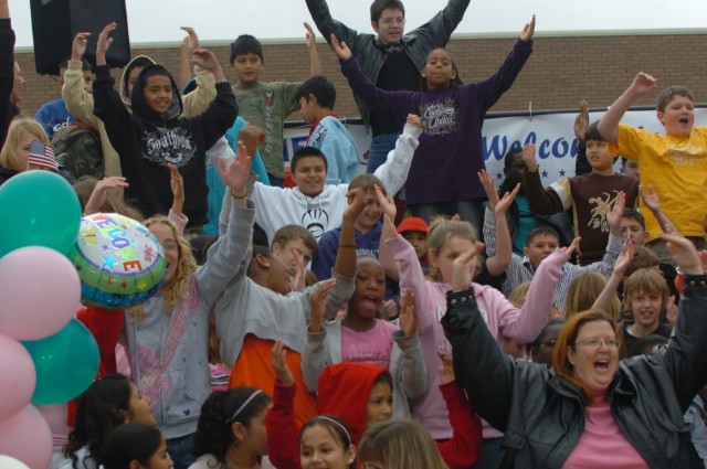 Students from McGregor, Texas', H.G. Isbill Junior High School dance to The Village People's "Y.M.C.A." during a 1st Cavalry Division home coming ceremony held at Cooper Field Jan. 16. The sixth-grade class won a trip to Fort Hood as a part of a scho...