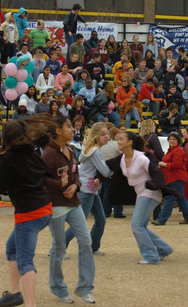Sixth graders from McGregor, Texas', H.G. Isbill Junior High School dance before a scheduled homecoming ceremony held at the 1st Cavalry Division's Cooper Field Jan. 16. Over 400 Soldiers with the First Team's 1st and 2nd Brigade were reunited with t...