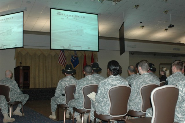 Soldiers with the 1st Cavalry Division watch the gun footage from the battle in An Najaf, Iraq, that resulted in Chief Warrant Officer 3 Zachary Johnson, a pilot with 4th Battalion, 227th Aviation Regiment, being awarded the Distinguished Flying...