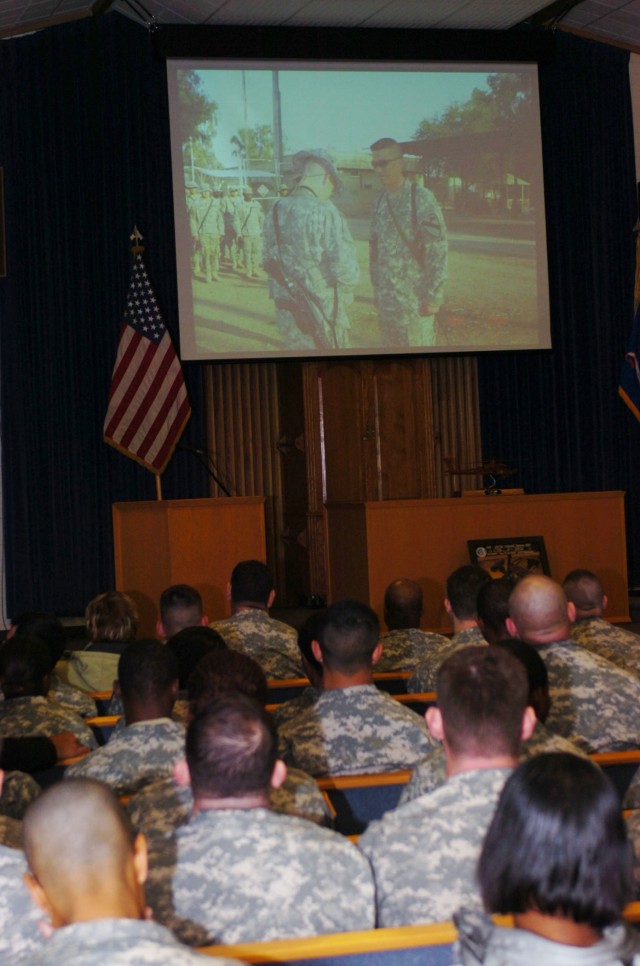 1st Cavalry Division Soldiers with the 4th "Guns" Battalion, 227th Aviation, 1st Air Cavalry Brigade watch photographic memories of Capt. Mark Resh and Chief Warrant Officer 3 Cornell Chao during a remembrance ceremony at West Fort Hood Chapel...