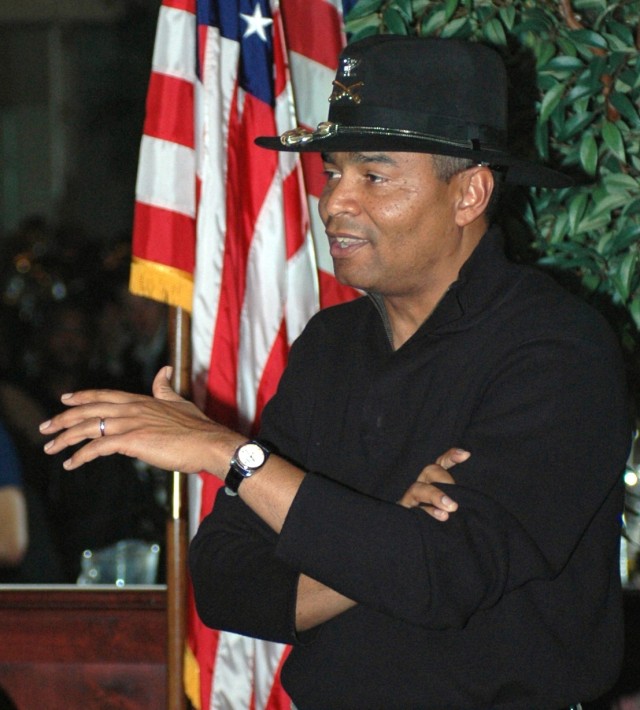 Col. Aundre Piggee, 15th Sustainment Brigade commander, addresses the Soldiers, officers, and civilians in attendance at the hail and farewell dinner Jan. 25.  Family members of many of those being honored at the dinner were present.  The spouses...