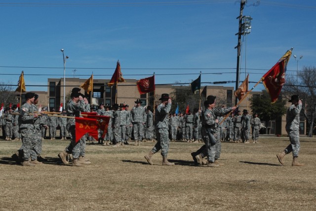 First Battalion, 82nd Field Artillery Soldiers with the 1st Cavalry Division's 1st "Ironhorse" Brigade Combat Team render salutes to the outgoing commander Maj. Gen. Joseph F. Fil, Jr., during an uncasing and relinquishment of command ceremony on...