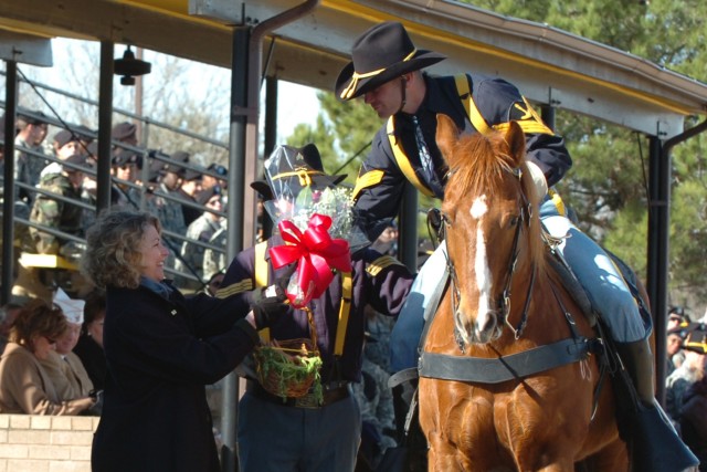 Linda Ordierno, the wife of Lt. Gen. Raymond Ordierno, commander of Fort Hood's III Corps, takes roses from Sgt. Justin Lidgitt of the 1st Cavalry Division's Horse Cavalry Detachment during a ceremony on Cooper Field at Fort Hood, Texas Feb. 1....
