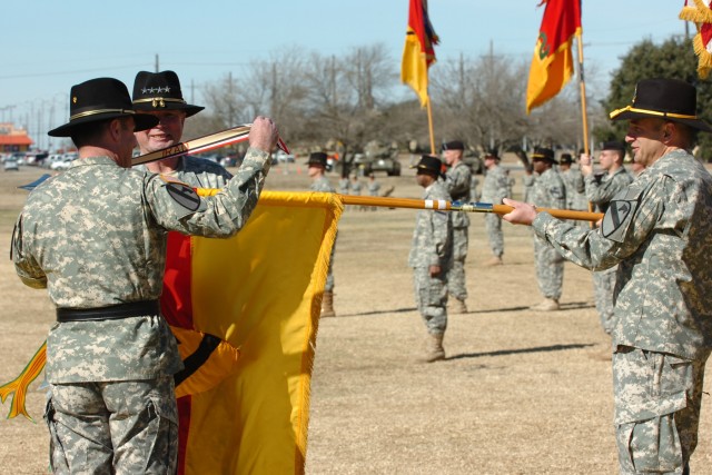Gen. Charles C. Campbell of Shreveport, La., commander of the U.S. Army Forces Command, assists Portola Valley, Calif., native Maj. Gen. Joseph F. Fil, Jr., outgoing commander of the 1st Cavalry Division in unfurling the division's colors...