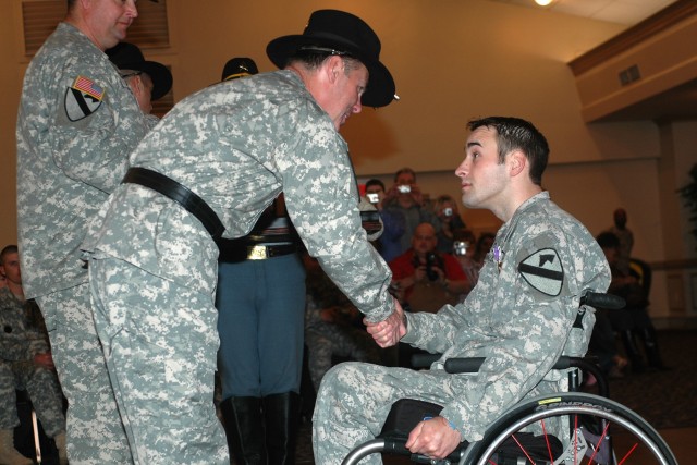Maj. Gen. (P) Joseph F. Fil Jr., the commanding general of 1st Cavalry Division, congratulates and welcomes home Spc. Brian Sawlsville, of 1st Brigade Combat Team, during the 1st Cavalry Division Purple Heart/Volunteer of the Month Ceremony held Jan....