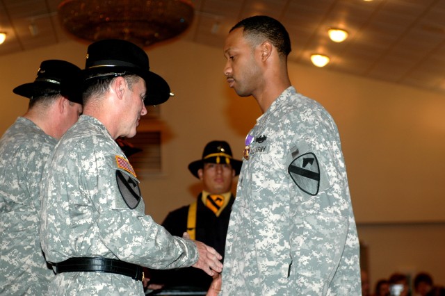 Sgt. Phillip Stockard, of Company B, 2nd Battalion, 8th Cavalry Regiment, is presented with his Purple Heart Medal by Maj. Gen. (P) Joseph F. Fil Jr., 1st Cavalry Division commander, during the 1st Cav. Div. Purple Heart and Volunteer of the Month Ce...