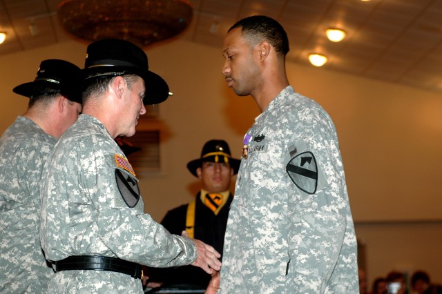 Sgt. Phillip Stockard, of Company B, 2nd Battalion, 8th Cavalry Regiment, is presented with his Purple Heart Medal by Maj. Gen. (P) Joseph F. Fil Jr., 1st Cavalry Division commander, during the 1st Cav. Div. Purple Heart and Volunteer of the Month...