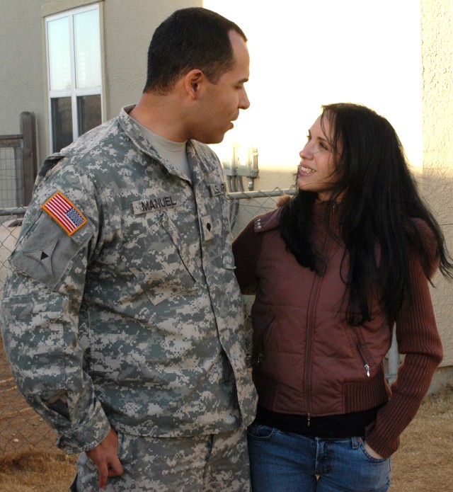 Spc. Alex Manuel and his wife, Veronica Manuel, talk in their back yard as their children play.  It took time for Alex to start feeling normal at home again after his 14 months in Iraq, but with the support of his loving family, the situation has...