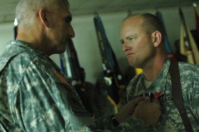 Maj. Gen. Mark P Hertling, commanding general of Multi-National Division-North and the 1st Armored Division, presents the Purple Heart to Col. David W. Sutherland, commander of the 3rd Brigade Combat Team, 1st Cavalry Division, after the brigade's...