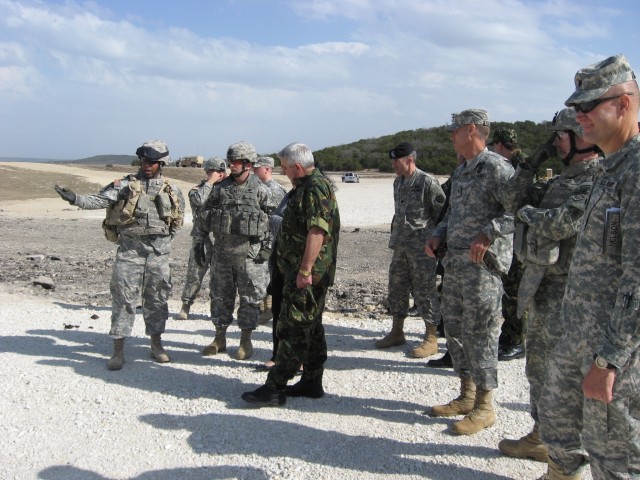 Sgt. 1st Class James Powell, Company B, 1st Battalion, 12th Infantry Regiment, briefs Bulgarian Lt. Gen. Ivan Dobrev on the unit's convoy live fire training Feb. 5. The general's visit to the training was part of his weeklong tour of various U.S. Arm...