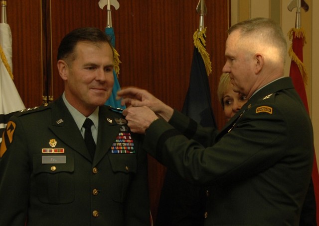Lt. Gen. Joseph F. Fil, Jr., 1st Cavalry Division's former commanding general gets pinned with his third star by Gen. Burwell Bell, III, the U.S. Forces Korea commanding general, (right) during a promotion ceremony. Fil took over command of the 8th U...