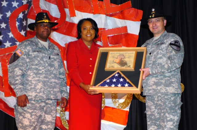 Principal Penny Batts (center) of Trimmier Elementary School receives a flag flown over Iraq from Lt. Col. Timothy DeVito (left), commander of the 4th "Guns" Battalion, 227th Aviation Regiment, 1st Air Cavalry Brigade, 1st Cavalry Division, and...