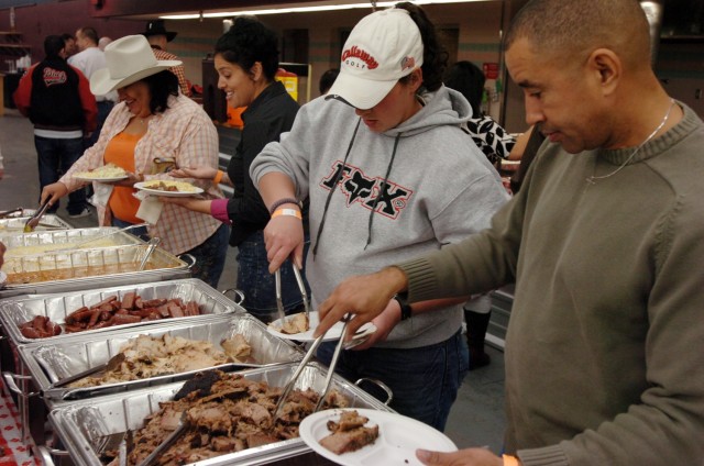 Soldiers with the 3rd "Gladiator" Brigade Special Troops Battalion, 3rd Brigade Combat Team, 1st Cavalry Division, grab a bite to eat at their Battalion Social, Feb. 15.  The event was a chance for the surrounding Fort Hood communities to welcome...