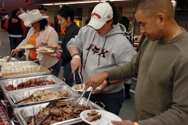 Soldiers with the 3rd "Gladiator" Brigade Special Troops Battalion, 3rd Brigade Combat Team, 1st Cavalry Division, grab a bite to eat at their Battalion Social, Feb. 15.  The event was a chance for the surrounding Fort Hood communities to welcome the...