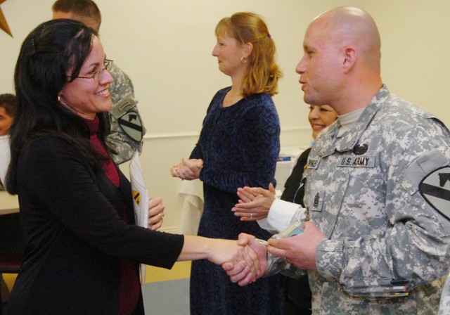 Command Sgt. Maj. Arthur Swingler, command sergeant major of 3rd Brigade Special Troops Battalion, 3rd Brigade Combat Team, 1st Cavalry Division, thanks Zulma Perez, wife of Chaplin (Capt.) Jesus Perez, during the 3rd BSTB Family Readiness Group...