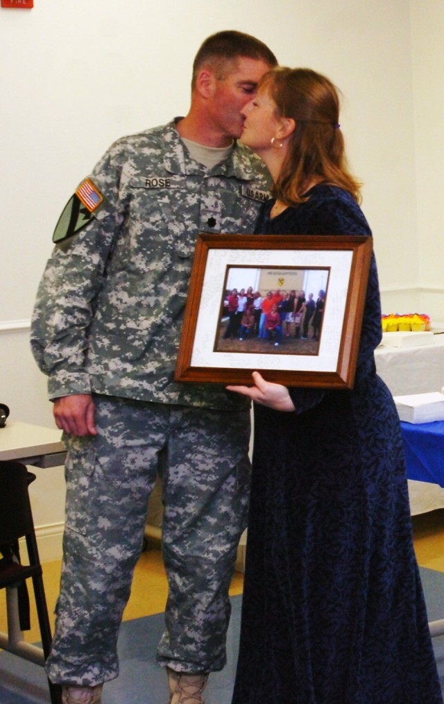 Lt. Col. Michael Rose, commander of 3rd Brigade special Troops Battalion, 3rd Brigade Combat Team, 1st Cavalry Division, kisses his wife, Kathy Rose, after she was awarded a picture frame of all the members of the 3rd BSTB Family Readiness Group,...