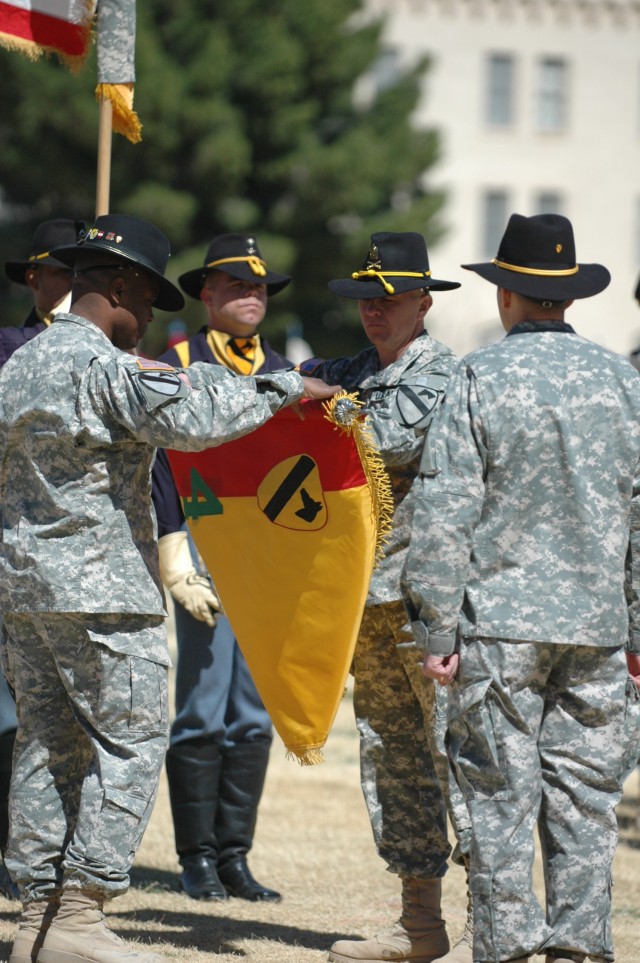 Col. Stephen Twitty, commander of the 4th Brigade Combat Team, 1st Armored Division (left) and Command Sgt. Maj. Stephan Frennier case the 4th Brigade Combat Team, 1st Cavalry Division during a noon re-flagging ceremony March 4 at Noel Field on...