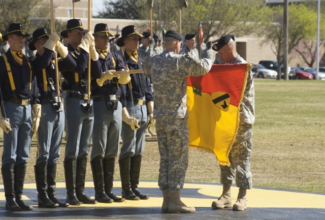 Col. Philip Battaglia, the 4th Brigade Combat Team commander, and Brigade Command Sgt. Maj. Edwin Rodriguez unveil their brigade's new colors during the Long Knife Brigade's re-flagging ceremony at 1st Cavalry Division's Cooper Field on Fort Hood, Te...