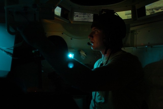 Sgt. Zach Berghammer, a tanker with Company C, 1st Battalion, 8th Cavalry Regiment, 2nd Brigade Combat Team, 1st Cavalry Division and Clarkston, Washington, native, mans the turret of a virtual M-1Abrams during a training exercise at the Close...