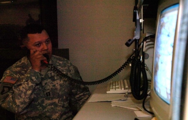 Capt. Miguel Juarez, commander Company C, 1st Battalion, 8th Cavalry Regiment, 2nd Brigade Combat Team, 1st Cavalry Division and Brownsville, Texas, native, maintains radio contact with troops during a virtual training exercise at the Close Combat...