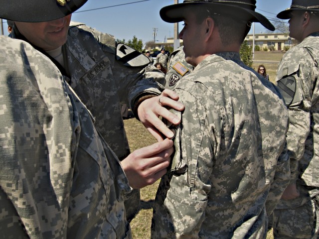 Lt. Col. Tim Norton, the 4th Special Troops Battalion commander, affixes a 1st Cavalry Division shoulder sleeve insignia patch to one of his Soldiers during a patch and Stetson donning ceremony the afternoon following the 4th Brigade Combat Team's...