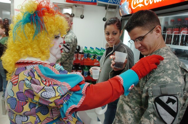 Mayjane DeBee from Houston, places a sticker on Spc. Wilmer Alverio, an Apache mechanic with the 3rd Battalion, 227th Aviation Regiment, 1st Air Cavalry Brigade, 1st Cavalry Division, as his wife Erika watches at a Soldier appreciation day hosted by ...