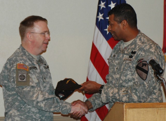 Brig. Gen. (P) Vincent K. Brooks, the 1st Cavalry Division's commanding general (left), gives Chaplain (Brig. Gen.) Donald L. Rutherford a Cav hat and a plaque to thank him the  serve themselves breakfast at the 1st Cav. Div.'s Welcome Home Prayer...