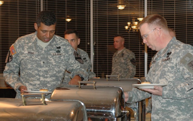Brig. Gen. (P) Vincent K. Brooks, the 1st Cavalry Division's commanding general (left), and Chaplain (Brig. Gen.) Donald L. Rutherford, the deputy chief of chaplains serve themselves breakfast at the 1st Cav. Div.'s Welcome Home Prayer Breakfast...