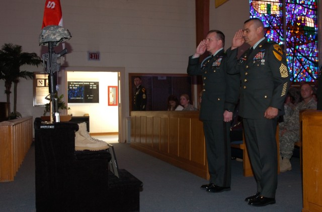 Lt. Col. Dale Kuehl (left), commander of 1st Battalion, 5th Cavalry Regiment, 2nd Brigade Combat Team, 1st Cavalry Division and the battalion's top enlisted Soldier, Command Sgt. Major Fidel Gomez, pay tribute to Spc. Joshua Carrol at a memorial...