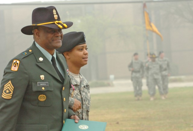 Retired Sgt. Maj. Larry Warren, 1st Cavalry Division's former G6 top noncommissioned officer, and his daughter Cadet Crystal Warren with the 712th Military Police Company, a National Guard unit operating out of Baytown, Texas, walk off of the...