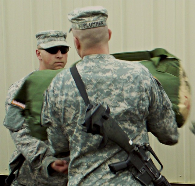 Soldiers from 4th Brigade Combat Team, 1st Cavalry Division, unload bags at Forward Operating Base Sword at the Joint Readiness Training Center in Fort Polk, La., March 11. The 1st Cavalry Division's new Long Knife Brigade is conducting its...