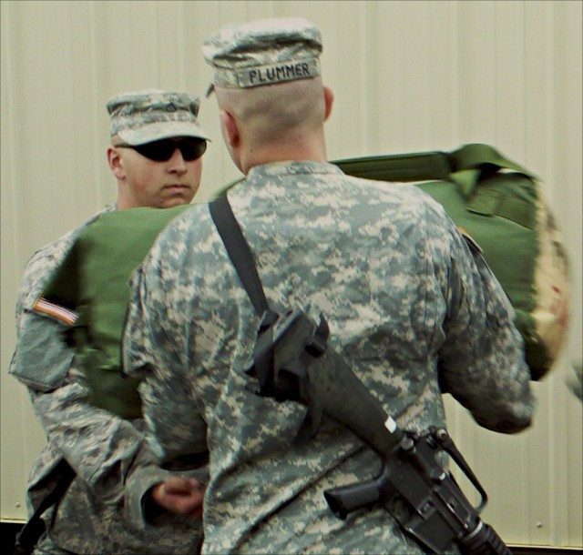 Soldiers from 4th Brigade Combat Team, 1st Cavalry Division, unload bags at Forward Operating Base Sword at the Joint Readiness Training Center in Fort Polk, La., March 11. The 1st Cavalry Division's new Long Knife Brigade is conducting its Mission R...