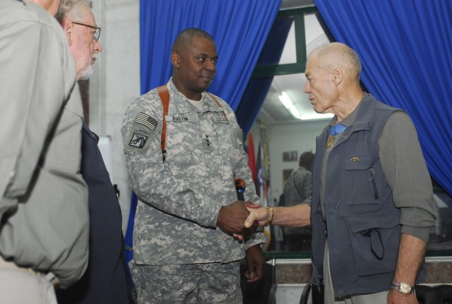 Lt. Gen. Lloyd J. Austin III, Commanding General of Multi National Corps Iraq, is presented with one of 300 coins