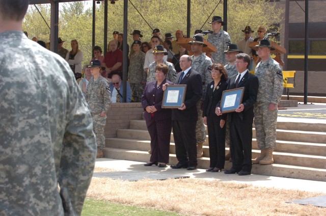 The parents of Capt. Mark Resh and Chief Warrant Officer 3 Cornell Chao listen to members of the 1st Cavalry Division band play a tribute to their sons during a Silver Star presentation ceremony held the division's parade field on Fort Hood, Texas, M...