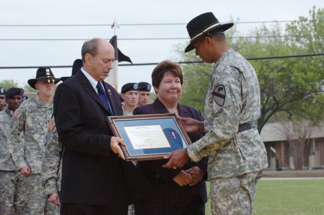 Brig. Gen. (P) Vincent Brooks, the commanding general of the 1st Cavalry Division, presents the Silver Star, the nation's third-highest award for valor, to the parents of Capt. Mark Resh, Charlie and Carol Resh from Fogelsville, Va., during a ceremon...