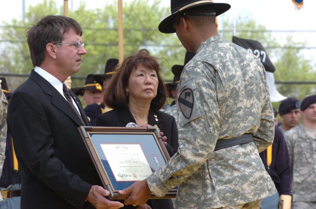 Brig. Gen. (P) Vincent Brooks, the commanding general of the 1st Cavalry Division, presents the Silver Star, the nation's third-highest award for valor, to the parents of Chief Warrant Officer 3 Cornell Chao, stepfather Glen Crowl and mother Jasmine ...