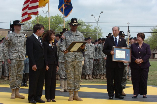 Brig. Gen. (P) Vincent Brooks, the commanding general of the 1st Cavalry Division, presents the Silver Star, the nation's third-highest award for valor, to the parents of Capt. Mark Resh and Chief Warrant Officer 3 Cornell Chao, both Apache pilots wi...