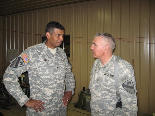 Brig. Gen. (P) Vincent K. Brooks (left), the commanding general of the 1st Cavalry Division speaks with Col. Philip Battaglia, the 4th Brigade Combat Team commander, during Brooks' visit to the 4 BCT's rotation at the Joint Readiness Training...
