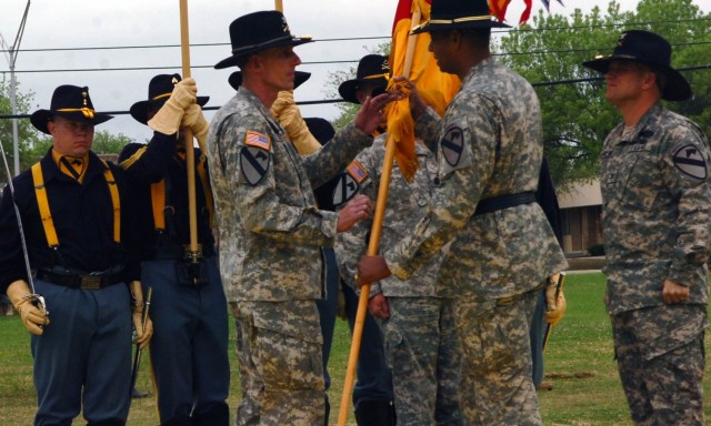 Col. Gary Volesky receives the 3rd Brigade Combat Team 1st Cavalry Division colors from Brig. Gen. Vincent Brooks, commanding general of the 1st Cavalry Division, signifying him taking charge of the unit during the brigade's change of command...