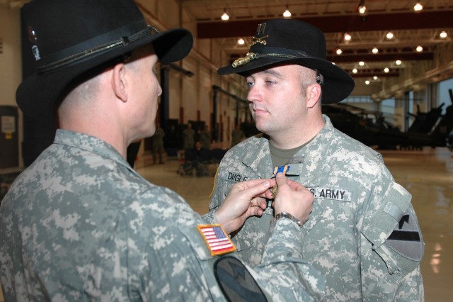 Las Vegas native Lt. Col. Christopher Walach (right), commander of the 1st "Attack" Battalion, 227th Aviation Regiment, 1st Air Cavalry Brigade, 1st Cavalry Division, pins an Air Medal with "V" device for Valor onto Fort Pierce, Fla., native Capt....