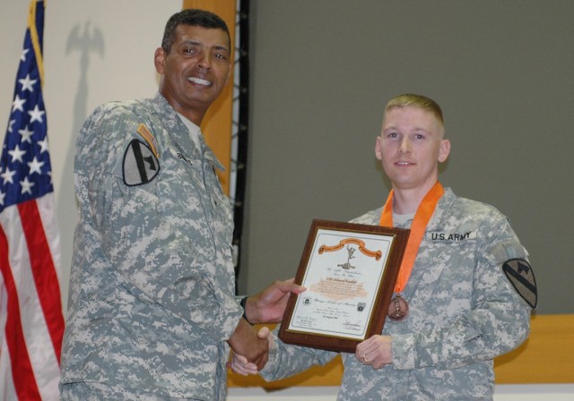 Maj. Edward Kendall, 1st Cavalry Division communications section or "G-6" networking officer poses with Brig. Gen. (P) Vincent K. Brooks, the commanding general of the division after recieving the medal for the Bronze Order of Mercury at a...