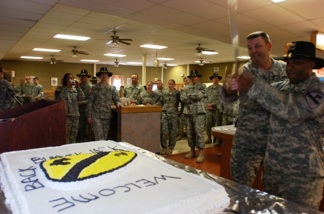 Col. Bryan Roberts, commander 2nd Brigade Combat Team, 1st Cavalry Division, and Command Sgt. Maj. James Lee, the 2nd Brigade's top noncommissioned officer, cut the "Cav" cake during the grand opening ceremony of the Black Jack Inn dining facility...