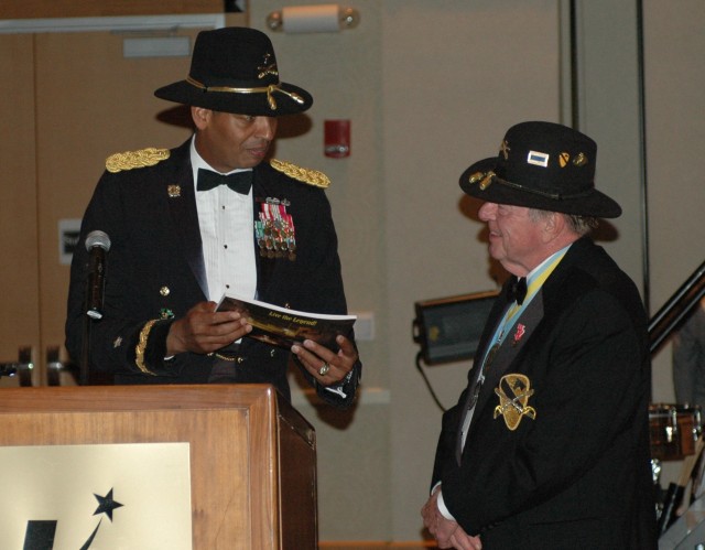 Brig. Gen. (P) Vincent K. Brooks, the commanding general of the 1st Cavalry Division, presents Joe Galloway, an author and journalist who was with the Cav in Vietnam, with an commemorative magazine of the division's deployment that was signed by...