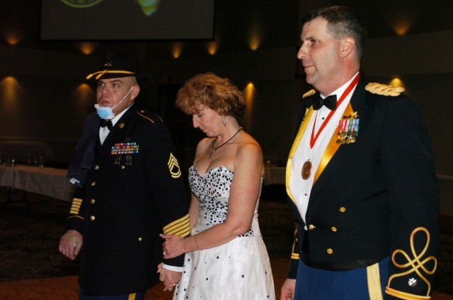 Sgt. 1st Class Carl Pasco (left) and his wife Joy were recently honored by Lt. Col. Jeffrey Sauer, commander 1st Battalion, 8th Cavalry Regiment, during the Mustang's ball event March 12. Carl was awarded a purple heart and a bronze star and Joy was ...