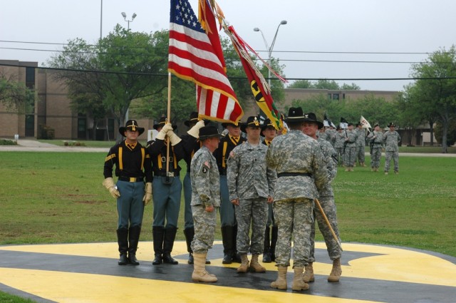 Col. Dan Shanahan passes the 1st Air Cavalry "Warrior" Brigade guidon to Brig. Gen. (P) Vincent Brooks, 1st Cavalry Division commander, as the brigade's top noncommissioned officer, Command Sgt. Maj. Scott Spiva, center, and the incoming...
