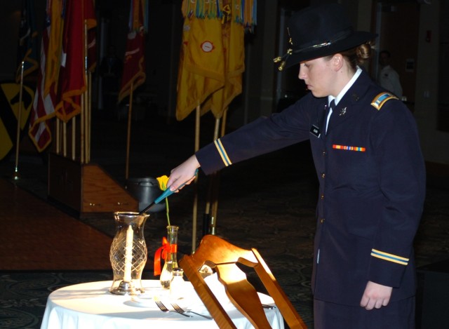 Fairfax, Va. native 2nd Lt. Mary Klavin, assistant brigade intelligence officer for the 1st Brigade Combat Team, 1st Cavalry Division, lights a candle in commemoration of fallen comrades as part of a fallen Soldier table display during the...