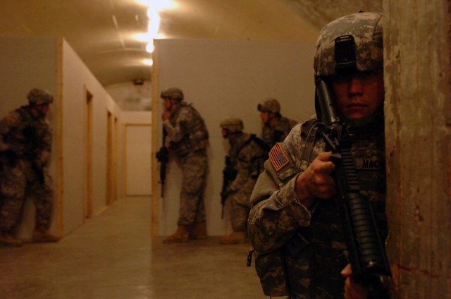 Pfc. Josh Macnicol, a native of St. Louis, pulls guard while his fellow Soldiers with Headquarters and Headquarters Company, 3rd Combined Arms Battalion, 8th Cavalry Regiment, 3rd Brigade Combat Team, 1st Cavalry Division, prepare to clear rooms in a...