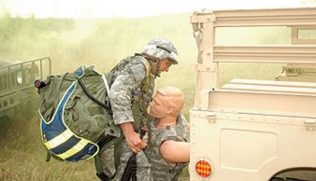 Spc. Daniel Farrier, Medical Command&#039;s Soldier of the Year, removes a mannequin simulating a casualty from a vehicle during the combat scenario part of the MEDCOM Best Warrior Co