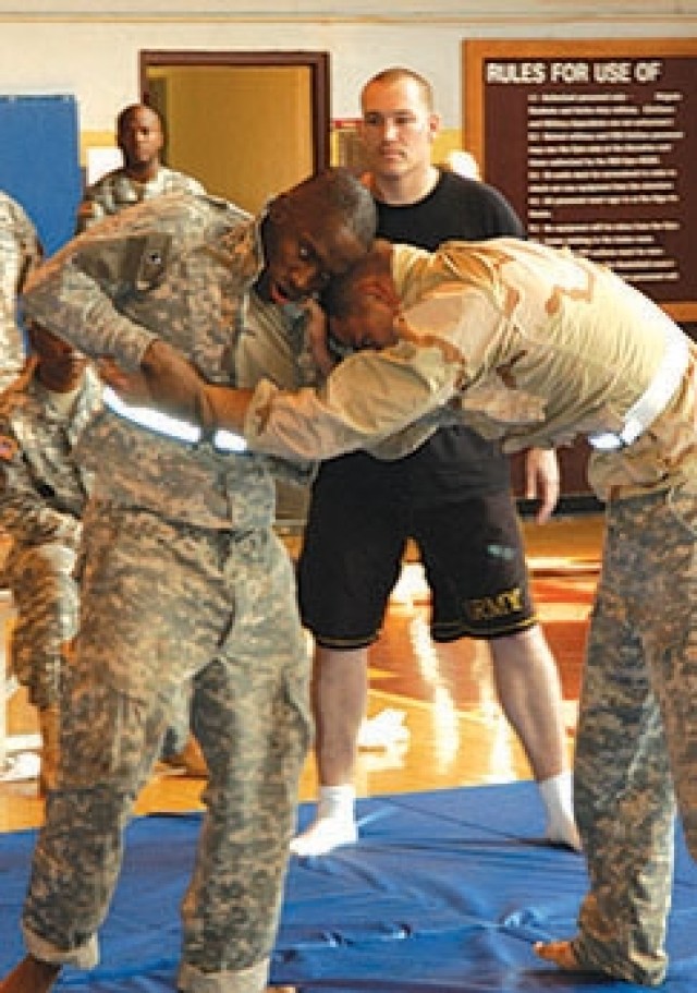 Staff Sgt. Julian R. Wiggins (left) grapples with Staff Sgt. Andrew Ruff during the combatives portion of the Medical Command Best Warrior Competition.